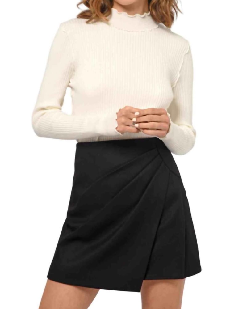 Front of a model wearing a size L Sarai Pleat Mini Skirt In Black in Black by GREYLIN. | dia_product_style_image_id:342390